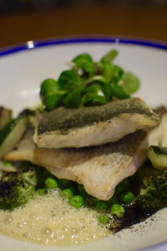 Sea bass filet with green vegetables and citrus sauce